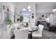 Bright dining room with glass-top table and white chairs at 2891 Swoop Cir, Kissimmee, FL 34741