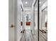 Long hallway with mirrored closet doors and wood-look floors at 2891 Swoop Cir, Kissimmee, FL 34741