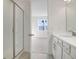 Bright bathroom with walk-in shower and white vanity at 4056 Bannock Ave, Tavares, FL 32778