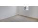 Simple bedroom with neutral walls, new carpet, and large window at 4056 Bannock Ave, Tavares, FL 32778