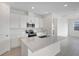 Modern kitchen with island, stainless steel appliances, and white cabinets at 4056 Bannock Ave, Tavares, FL 32778