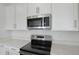 Modern kitchen with stainless steel appliances and white shaker cabinets at 4056 Bannock Ave, Tavares, FL 32778