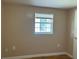 Simple bedroom with wood floors and a window at 109 N Palm Ave, Kissimmee, FL 34741