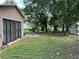 Backyard with shed, green grass, and palm trees at 109 N Palm Ave, Kissimmee, FL 34741