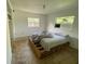 Simple bedroom with a pallet bed frame and two windows at 316 Pennsylvania Ave, Saint Cloud, FL 34769
