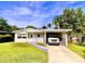 Single-story home with attached carport and a spacious yard at 316 Pennsylvania Ave, Saint Cloud, FL 34769