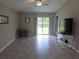 Living room with tile floors, sliding door, and a ceiling fan at 1629 Yellow Trl, Lakeland, FL 33801