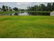 Spacious backyard with pond view and lush green grass at 1629 Yellow Trl, Lakeland, FL 33801