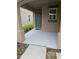 A small front porch with a teal door and freshly painted floor at 1629 Yellow Trl, Lakeland, FL 33801