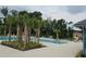 Community pool with lounge chairs and palm trees at 1629 Yellow Trl, Lakeland, FL 33801