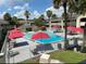 Refreshing motel pool with red umbrellas and plenty of lounge chairs at 5245 W Irlo Bronson Memorial Hwy # 234, Kissimmee, FL 34746