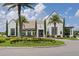 Elegant community clubhouse with landscaping and palm trees at 15620 Panther Lake Dr, Winter Garden, FL 34787