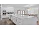 Open concept kitchen with white cabinets and expansive island at 15620 Panther Lake Dr, Winter Garden, FL 34787