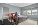 Bedroom with king-size bed, gaming chair, and multiple windows at 15620 Panther Lake Dr, Winter Garden, FL 34787