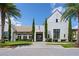 White community clubhouse entrance with landscaping at 15620 Panther Lake Dr, Winter Garden, FL 34787