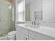 Modern bathroom with a walk-in shower and white cabinets at 15620 Panther Lake Dr, Winter Garden, FL 34787