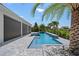 Large pool with a spa, waterfall, and palm trees at 15620 Panther Lake Dr, Winter Garden, FL 34787