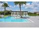 Community pool with a water feature and lounge chairs at 15620 Panther Lake Dr, Winter Garden, FL 34787
