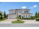 Two-story house with a three car garage and landscaping at 15620 Panther Lake Dr, Winter Garden, FL 34787