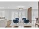 Bright living room with four blue armchairs and large windows at 15620 Panther Lake Dr, Winter Garden, FL 34787