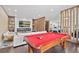 Game room with pool table, fireplace, and open view to kitchen at 15620 Panther Lake Dr, Winter Garden, FL 34787
