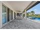 Outdoor kitchen and patio area with seating and a pool view at 15620 Panther Lake Dr, Winter Garden, FL 34787