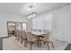 Bright dining room with a large table and modern chandelier at 15620 Panther Lake Dr, Winter Garden, FL 34787