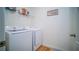 Laundry room with washer, dryer, and shelving at 2378 White Lilly Dr, Kissimmee, FL 34747