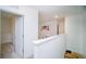 Upstairs hallway with neutral carpet and doors to bedrooms at 2378 White Lilly Dr, Kissimmee, FL 34747