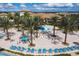 Community pool with lounge chairs and umbrellas at 1038 Splash Shot Pl, Davenport, FL 33896