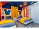 Mickey and Minnie Mouse themed bedroom with two twin beds at 1038 Splash Shot Pl, Davenport, FL 33896