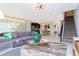 Open concept living area with modern furniture and a view of the kitchen at 1038 Splash Shot Pl, Davenport, FL 33896