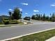 Asphalt road with landscaping and streetlights at 4520 Gliding Wave St, Winter Garden, FL 34787