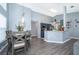 Bright dining area adjacent to kitchen with modern light fixture at 104 Langham Dr, Davenport, FL 33897