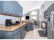 Open concept kitchen with granite countertops and stainless steel appliances at 104 Langham Dr, Davenport, FL 33897