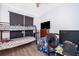 Bedroom with bunk beds, dresser, and a large TV at 104 Langham Dr, Davenport, FL 33897