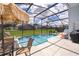 Relaxing screened pool area with patio furniture and grill at 104 Langham Dr, Davenport, FL 33897