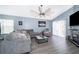 Living room with sectional sofa, fireplace and sliding glass doors at 104 Langham Dr, Davenport, FL 33897