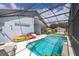 Screened pool with kayaks and floats at 104 Langham Dr, Davenport, FL 33897