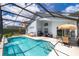 Large screened pool with patio furniture and grill at 104 Langham Dr, Davenport, FL 33897