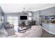 Open living room with fireplace, vaulted ceiling, and view of kitchen and pool at 104 Langham Dr, Davenport, FL 33897