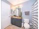 Clean bathroom with granite countertop, gray vanity, and updated fixtures at 104 Langham Dr, Davenport, FL 33897