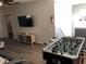 Finished basement featuring foosball and a large TV at 5265 Oakbourne Ave, Davenport, FL 33837