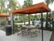 Covered seating area with tables and chairs near the pool at 5265 Oakbourne Ave, Davenport, FL 33837