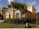 Two-story house with attached garage and palm trees at 5265 Oakbourne Ave, Davenport, FL 33837