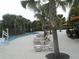 Relaxing poolside scene with lounge chairs and palm trees at 5265 Oakbourne Ave, Davenport, FL 33837