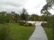 Community pool with lounge chairs, palm trees, and shaded seating areas at 5265 Oakbourne Ave, Davenport, FL 33837