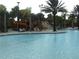 Community pool with waterslide and rock waterfall feature at 5265 Oakbourne Ave, Davenport, FL 33837