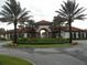 Attractive community entrance with palm trees and Spanish-style architecture at 5265 Oakbourne Ave, Davenport, FL 33837