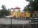Modern playground with slides, climbing structures, and a fenced area at 5265 Oakbourne Ave, Davenport, FL 33837